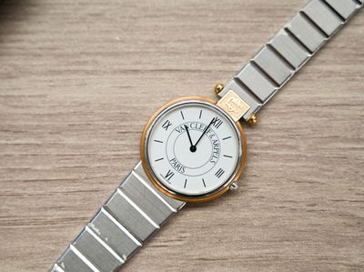 a close up of a wrist watch on a wooden table