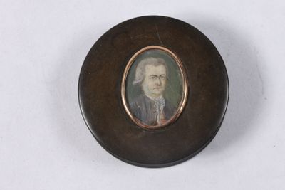an old picture of a man in a suit and tie in a wooden box