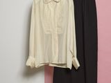 two pieces of clothing hanging on a rack in front of a pink wall