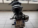 a motorcycle that is parked in front of a window