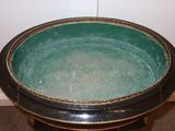 a black and green bowl sitting on top of a table