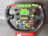 the steering wheel of a race car with buttons and numbers on it