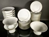 a lot of plates and bowls sitting on a table