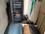 a small room with a microwave and a box on the floor