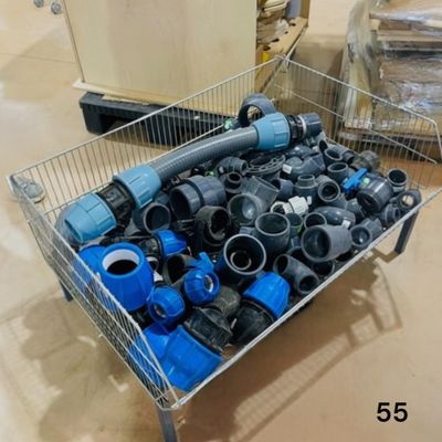 a metal cart filled with different types of pipes and fittings