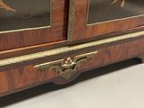 a wooden cabinet with a floral design on the doors