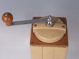 a small wooden box with a metal handle and a wooden knob