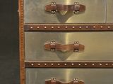 an image of a metal and leather chest of drawers