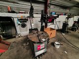 an image of a man working on a machine in a garage