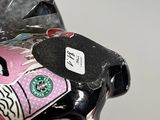 a close up of a motorcycle with a pink and black design on it