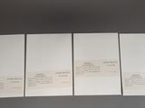 four pieces of white paper sitting on top of a table