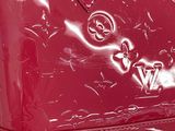 a close up of a red louis vuitton bag