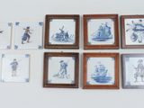 six framed pictures on the wall of a room