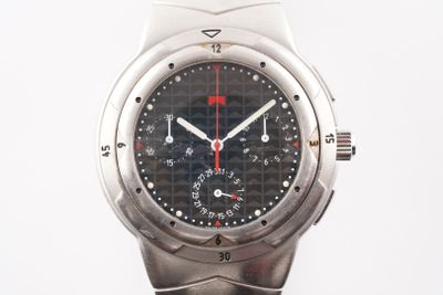 a close up of a watch on a white surface