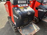 two red and black tractors parked next to each other