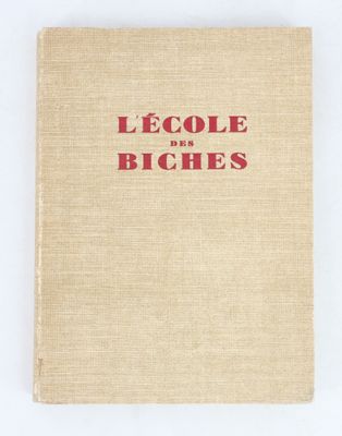 a book with red lettering on it sitting on top of a white surface