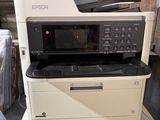 a stack of printers and a printer sitting on top of each other
