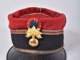 a red hat with a gold leaf on it