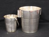 silver plated pitcher and cup set on a black background