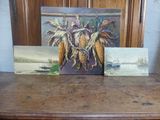 trois tableaux représentant du maïs, posés côte à côte sur une table