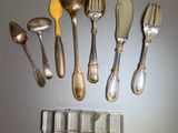 a lot of silverware on a table with spoons and forks