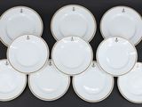 six assiettes en porcelaine blanche et dorée, avec des bords dorés
