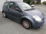 a picture of a small blue car parked in a parking lot