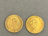 two gold sovereigns, one with the head of a man and one with a woman