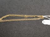 a close up of a gold chain with a tag attached to it
