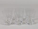 three shot glasses sitting next to each other on a white surface