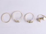 four gold rings and a ring with a cat on it