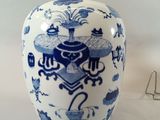 a blue and white vase sitting on a white table