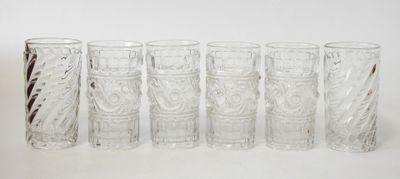 six glasses sitting next to each other on a table