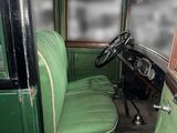 an old green car with a green seat and a steering wheel
