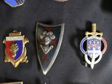 a lot of badges that are on a black surface