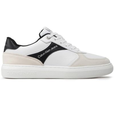 a white and black sneaker with a logo on the side