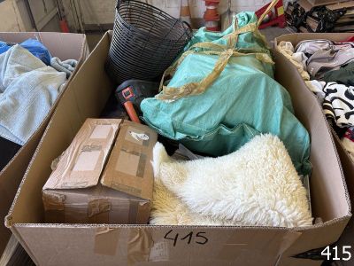 a cardboard box filled with clothes and other items