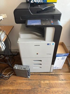 a printer sitting on top of a desk next to a printer
