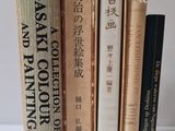 several books are stacked on top of each other on a table