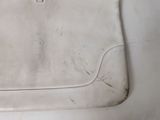 a white purse sitting on top of a white table