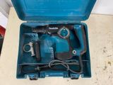 a blue tool in a blue case on the floor