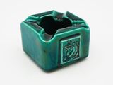 an image of a green ceramic ashtray with a dragon on it