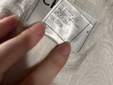 someone is holding a label on a white dress that says chanel
