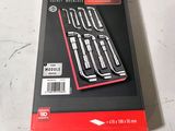 a box of tools sitting on a table next to a pair of scissors