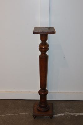 a small wooden table with a wooden top on the floor