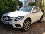 La Mercedes GLC est garée devant une maison