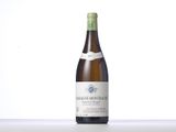 the bottle of white wine is sitting on the table