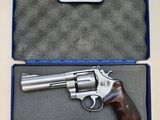 a gun in a case on a table with a blue handle