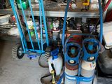 a blue cart with gas bottles and other items in a garage