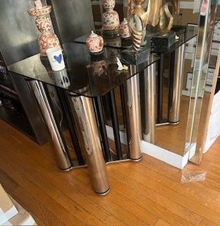 a glass table with a mirror on top of it in a room